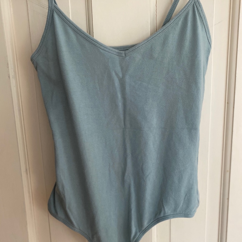 Light green body suit.
